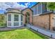 Exterior elevation of a charming home with a brick entry, and a well manicured lawn and lush, mature landscaping at 10822 Eagle Crest Ct, Parker, CO 80138