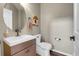 Half bath with modern vanity, decorative mirror and light fixtures, and a white toilet at 10822 Eagle Crest Ct, Parker, CO 80138