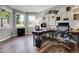 A modern office features hardwood floors, neutral walls and a collection of art pieces on the wall at 10822 Eagle Crest Ct, Parker, CO 80138