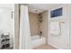 Cozy bathroom featuring a tiled shower-tub with a decorative shower curtain at 1870 S Ogden St, Denver, CO 80210