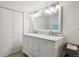 Bright bathroom features double sinks with marble counters and white cabinets at 1870 S Ogden St, Denver, CO 80210