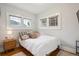 Inviting bedroom features hardwood floors and natural light from two windows at 1870 S Ogden St, Denver, CO 80210
