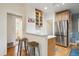 Eat-in kitchen with stainless steel appliances and bar seating providing a casual dining experience at 1870 S Ogden St, Denver, CO 80210