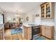 Open layout with kitchen flowing into the dining room, featuring stainless steel appliances and hardwood floors at 1870 S Ogden St, Denver, CO 80210