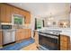Bright kitchen featuring stainless steel appliances, light wood cabinets, and a seamless connection to the dining area at 1870 S Ogden St, Denver, CO 80210