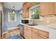 Sunlit kitchen boasting stainless steel appliances, tiled backsplash, and ample natural light from large windows at 1870 S Ogden St, Denver, CO 80210