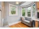 Bright kitchen nook features a comfortable bench under bay windows, creating a cozy dining space at 1870 S Ogden St, Denver, CO 80210