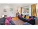 Bright living room features stylish sofas, a large window, and hardwood floors for a cozy, inviting space at 1870 S Ogden St, Denver, CO 80210