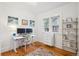 Bright home office with modern desk setup and ample shelving for organized workspace at 1870 S Ogden St, Denver, CO 80210