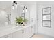 Elegant bathroom featuring double vanity with sleek countertops and a glass-enclosed shower at 1750 Wewatta St # 1825, Denver, CO 80202