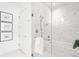Bright bathroom showcasing marble tile in shower and tub with seamless glass door at 1750 Wewatta St # 1825, Denver, CO 80202