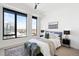 Bright bedroom features a large window, comfortable bed, and stylish decor at 1750 Wewatta St # 1825, Denver, CO 80202