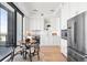 Bright kitchen with white cabinets, stainless steel appliances, and a cozy dining area with city views at 1750 Wewatta St # 1825, Denver, CO 80202
