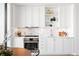 Well-lit kitchen featuring sleek white cabinets, stainless steel oven, and stylish decor with a marble backsplash at 1750 Wewatta St # 1825, Denver, CO 80202