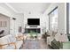 Bright living room featuring a modern fireplace, large window, comfortable seating, and stylish decor at 1750 Wewatta St # 1825, Denver, CO 80202