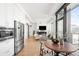 Spacious living area with a modern kitchen, fireplace, cozy seating, and a balcony offering breathtaking city views at 1750 Wewatta St # 1825, Denver, CO 80202