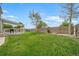 The backyard features a large green lawn with a covered deck and wood fence at 13152 E 104Th Dr, Commerce City, CO 80022