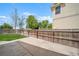 The backyard features a spacious concrete patio area with a wood fence and a view of the yard at 13152 E 104Th Dr, Commerce City, CO 80022