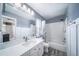 Bright bathroom features a white marble vanity, modern fixtures, and a shower over a soaking tub at 13152 E 104Th Dr, Commerce City, CO 80022