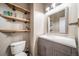 Powder room with modern vanity, quartz countertop, and open shelving at 13152 E 104Th Dr, Commerce City, CO 80022