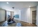 Charming bedroom featuring a Murphy bed, bike trainer, and shelves for organization and hard wood floors at 13152 E 104Th Dr, Commerce City, CO 80022
