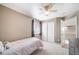 Comfortable bedroom features a ceiling fan, closet, and window providing natural light and carpet floors at 13152 E 104Th Dr, Commerce City, CO 80022