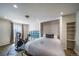 Charming bedroom featuring a Murphy bed, bike trainer, and shelves for organization and carpet floors at 13152 E 104Th Dr, Commerce City, CO 80022