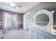 Bright bedroom featuring a single bed, charming curtains, and a dresser complemented by a vanity mirror at 13152 E 104Th Dr, Commerce City, CO 80022