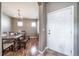 Formal dining room with chandelier lighting, hardwood floors, and view to front door at 13152 E 104Th Dr, Commerce City, CO 80022