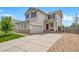Charming two-story home with a well-maintained front yard, concrete driveway, and an attached garage at 13152 E 104Th Dr, Commerce City, CO 80022
