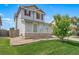 Landscaped front yard with a well-maintained lawn, rock accents and decorative tree at 13152 E 104Th Dr, Commerce City, CO 80022