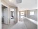 Bright hallway with neutral walls, white trim, and plush carpeting leading to bedrooms with ample natural light at 13152 E 104Th Dr, Commerce City, CO 80022