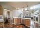 Kitchen with stainless steel dishwasher and a view to the Gathering room and staircase at 13152 E 104Th Dr, Commerce City, CO 80022