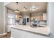 Functional kitchen with stainless steel appliances, breakfast bar, and modern lighting fixtures at 13152 E 104Th Dr, Commerce City, CO 80022