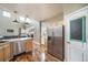 Open-concept kitchen with stainless appliances, wood floors, and access to the living area at 13152 E 104Th Dr, Commerce City, CO 80022