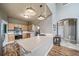 Bright kitchen with wood floors, light wood cabinets, stainless steel appliances, and a spacious breakfast bar at 13152 E 104Th Dr, Commerce City, CO 80022