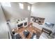 Spacious living room with high ceilings, fireplace, wood floors, and open to kitchen at 13152 E 104Th Dr, Commerce City, CO 80022