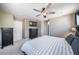 Well-appointed primary bedroom featuring ceiling fan, and a modern dresser beneath wall-mounted television at 13152 E 104Th Dr, Commerce City, CO 80022