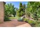 A serene backyard patio with lounge chairs surrounded by lush greenery and a charming wooden fence at 3933 W 102Nd Ave, Westminster, CO 80031