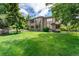 Spacious backyard with lush green lawn and mature trees providing shade and privacy for outdoor enjoyment at 3933 W 102Nd Ave, Westminster, CO 80031
