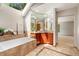 Bright bathroom with a garden tub, granite counters, and an array of natural light from a large skylight at 3933 W 102Nd Ave, Westminster, CO 80031