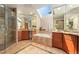 Luxurious bathroom with skylight, double vanity, soaking tub, and walk-in shower at 3933 W 102Nd Ave, Westminster, CO 80031