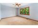 Bright bedroom with a ceiling fan, neutral carpet, and a window with lovely views of mature trees at 3933 W 102Nd Ave, Westminster, CO 80031