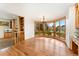 Light filled dining room with bay window, wood floors, and adjacent to a brick fireplace at 3933 W 102Nd Ave, Westminster, CO 80031