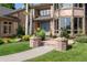 Inviting front entrance with brick pillars, walkway, blue door, and lush landscaping at 3933 W 102Nd Ave, Westminster, CO 80031