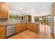 Spacious kitchen has wood cabinets, stainless steel appliances, and is open to the dining room at 3933 W 102Nd Ave, Westminster, CO 80031