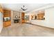 Spacious living room boasts a brick fireplace with built-in shelving, and access to the kitchen at 3933 W 102Nd Ave, Westminster, CO 80031