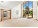 Bright living room with large windows, fireplace, and neutral carpet at 3933 W 102Nd Ave, Westminster, CO 80031