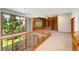 Bright loft space with wooden bookshelves and trim, and large picture windows showcasing the green outdoors at 3933 W 102Nd Ave, Westminster, CO 80031