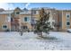 Home backyard with snow featuring multiple decks, landscaping, and scenic charm at 13025 W 63Rd Pl # C, Arvada, CO 80004